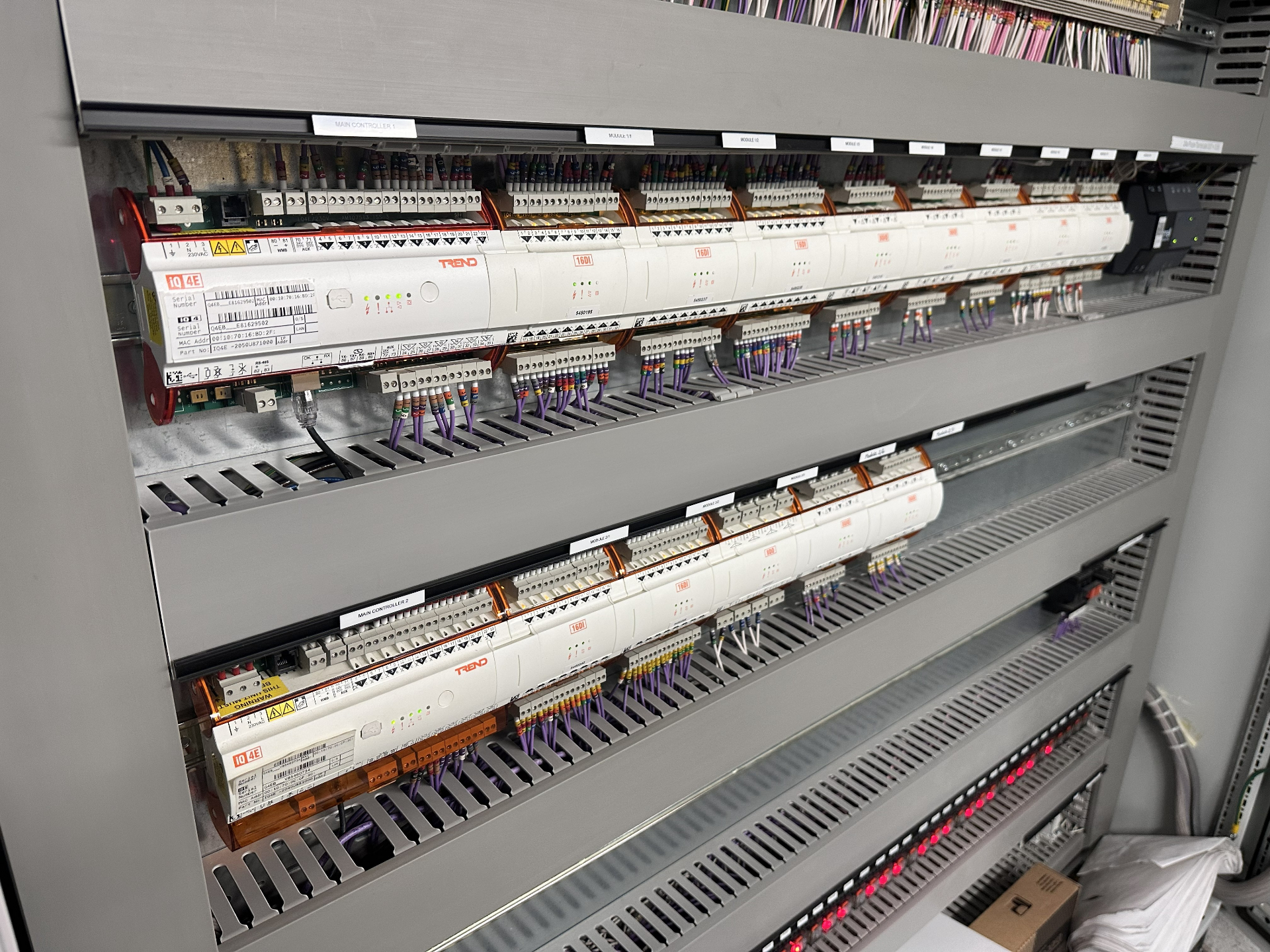 Trend IQ4E BMS controllers and 16DI modules mounted in a live MCC panel